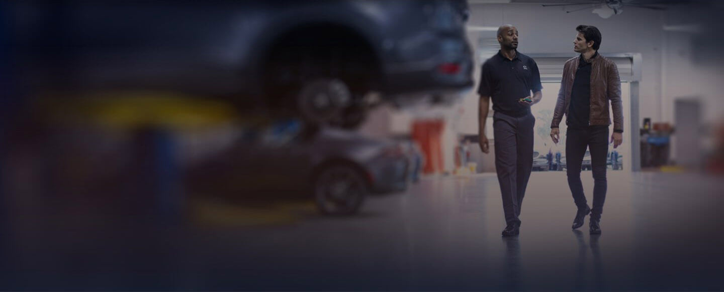 Technician talking to Mazda customer
